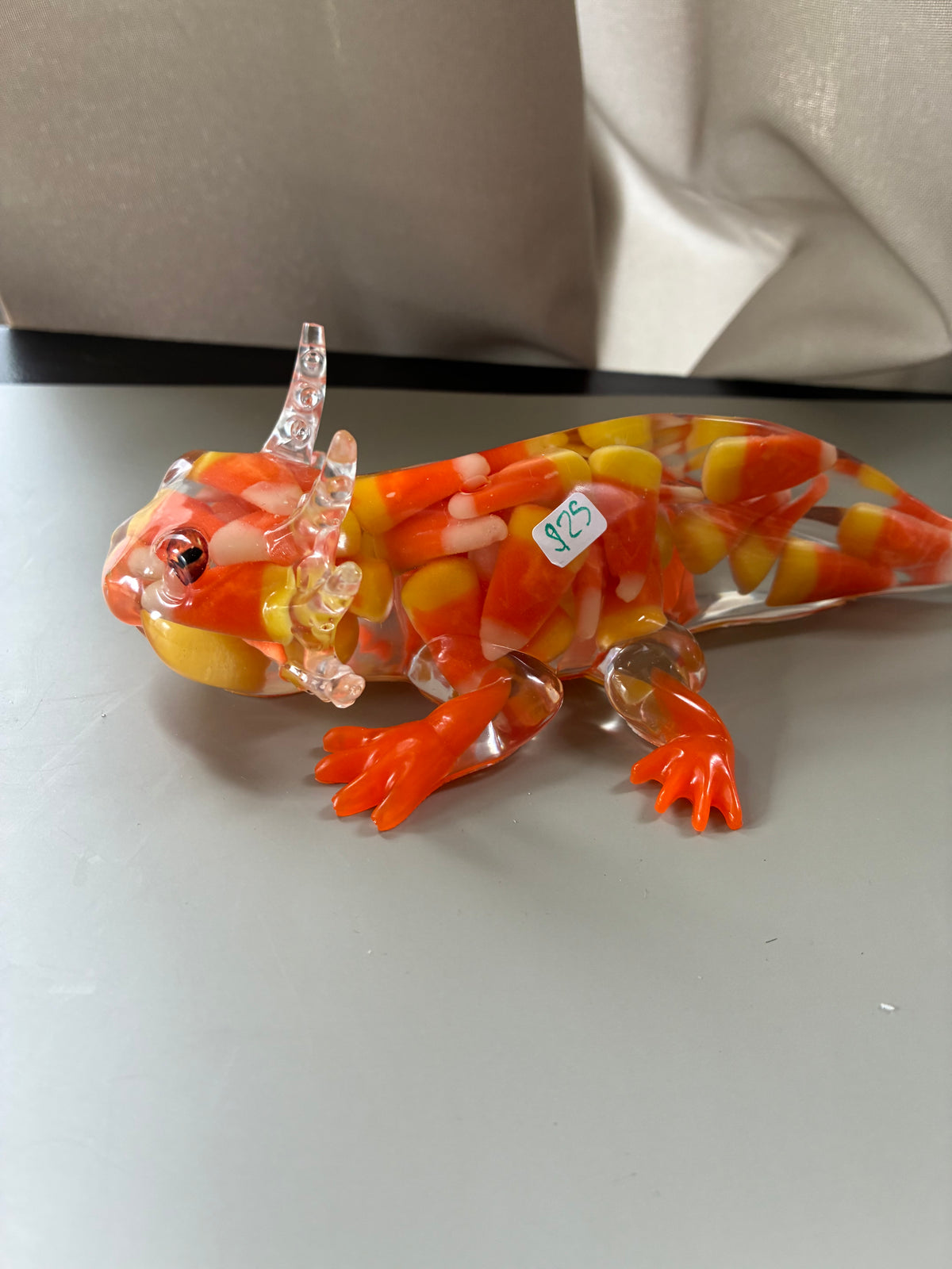 Candy corn resin axolotl figurine in orange yellow and white