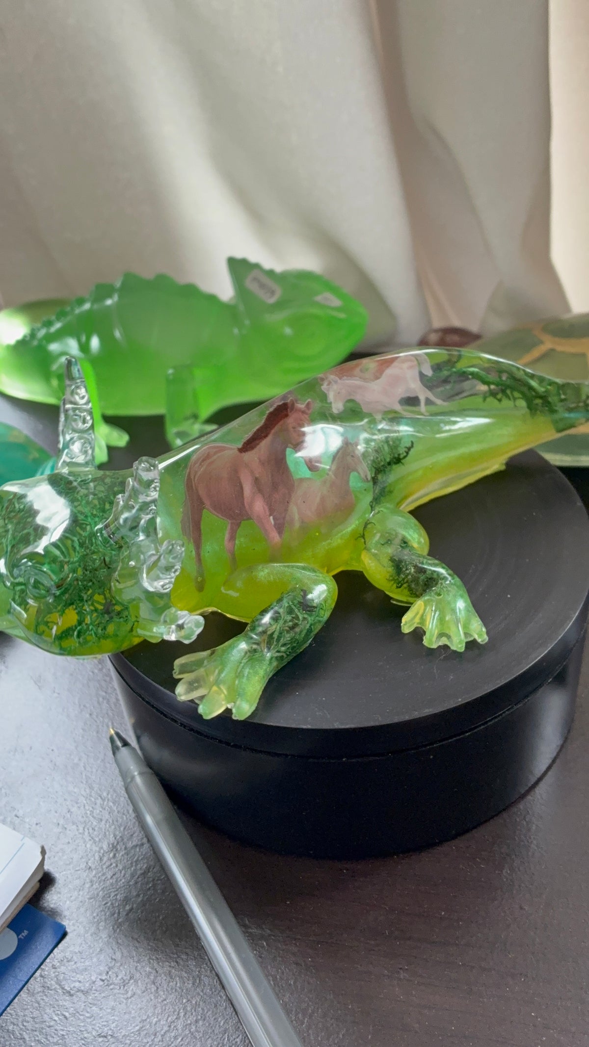 Green resin axolotl figurine with wild horse design and moss accents