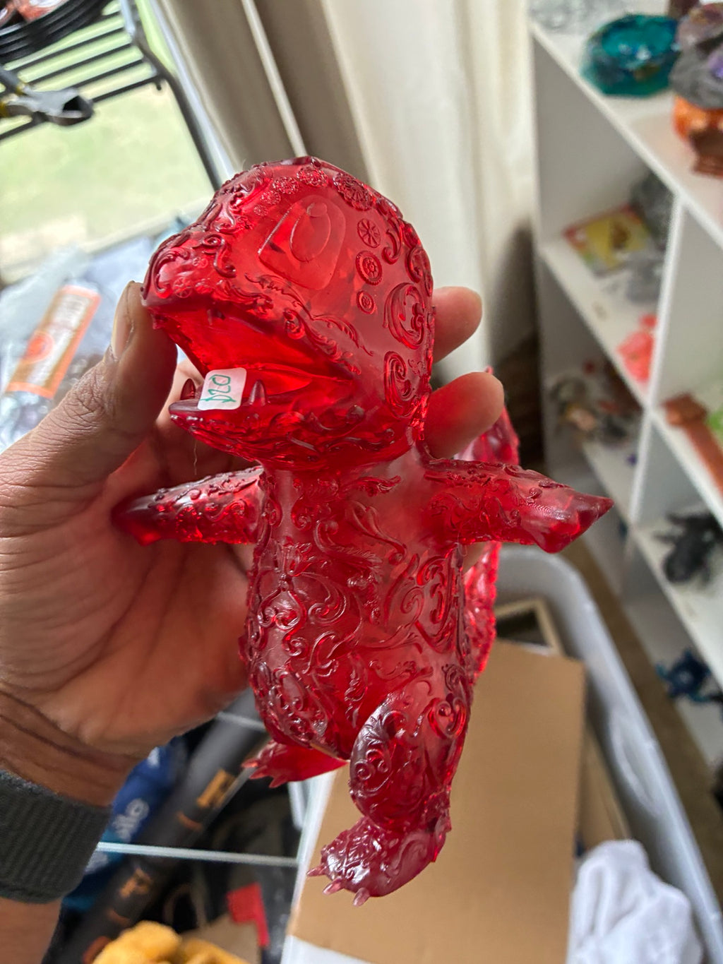 Red translucent hollow Charmander-inspired UV resin 3D printed figure, angled front view