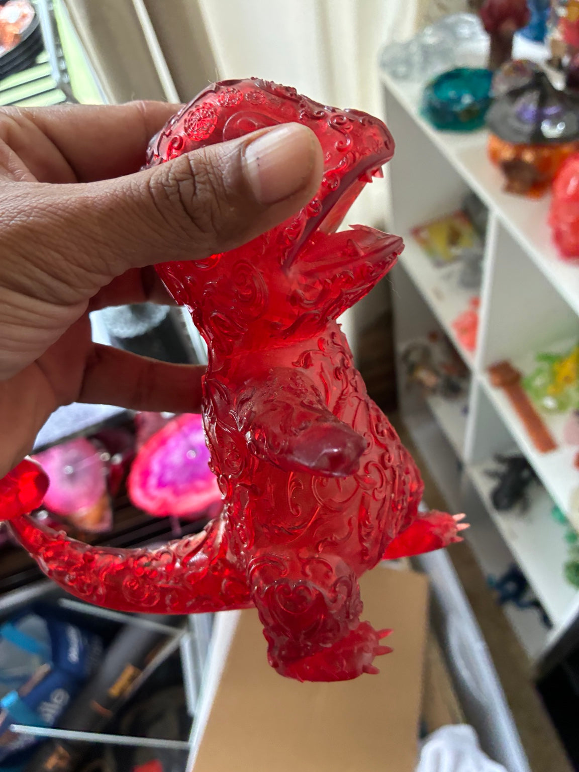 Red translucent Charmander-inspired UV resin 3D printed figure, side profile with flame tail