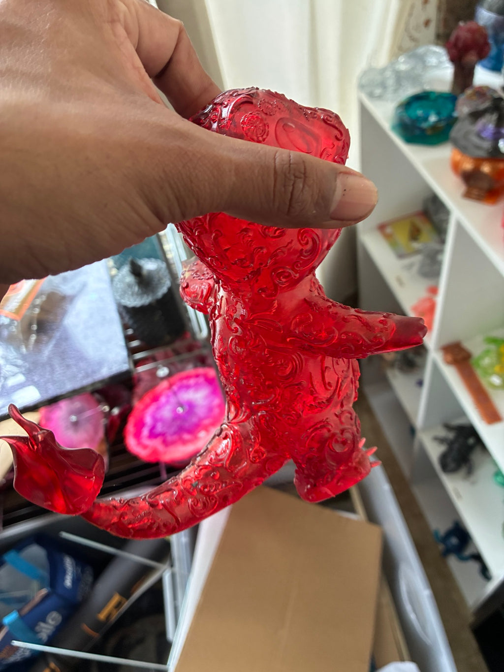 Back view of red translucent hollow Charmander-inspired UV resin 3D printed figure