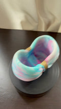 Cotton candy tie-dye resin bow holder in pastel blue, pink and white with gold center detail