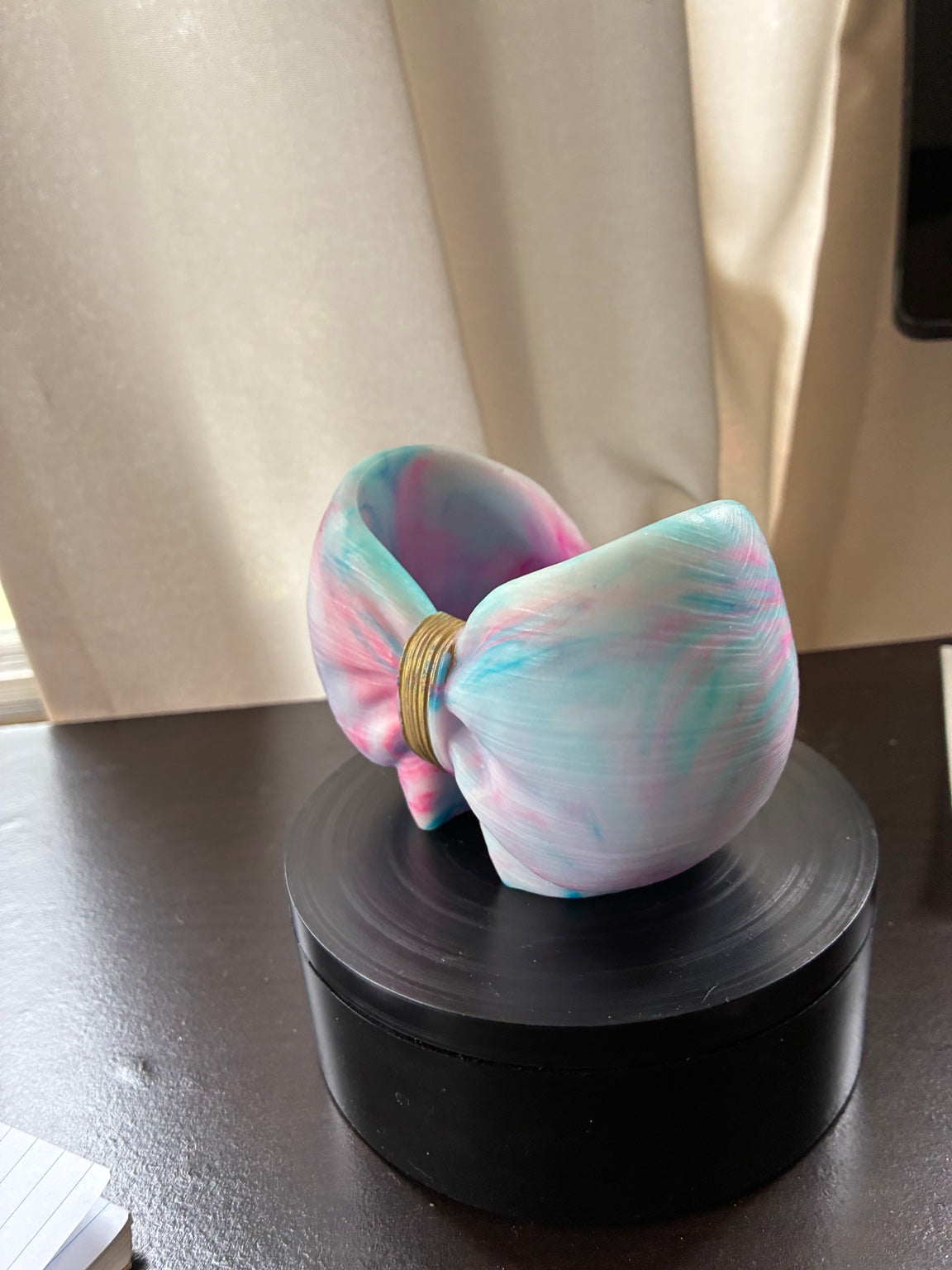 Angled view of pastel cotton candy tie-dye resin bow holder