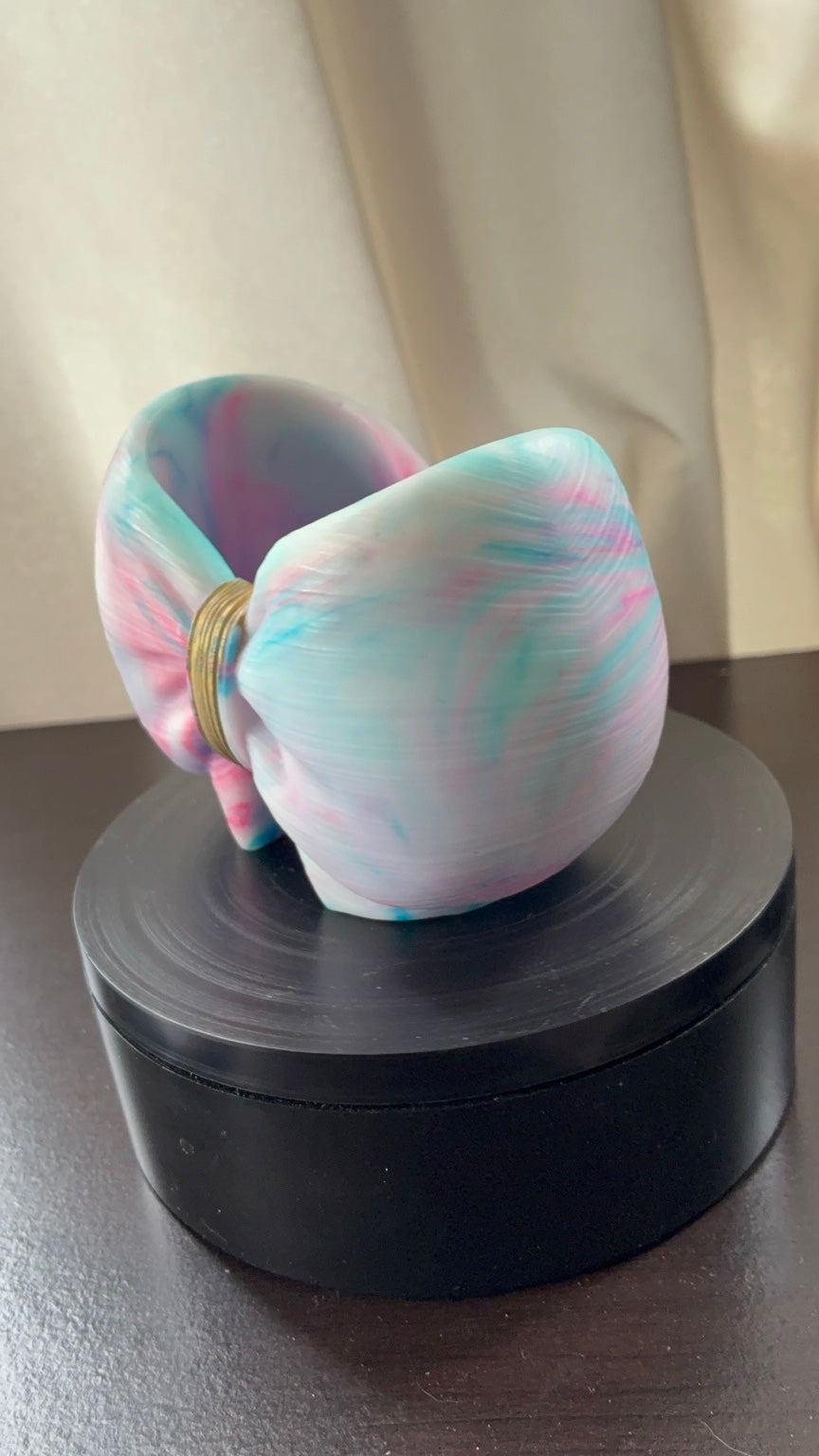 Pastel cotton candy tie-dye resin bow holder with aqua blue pink and white swirls