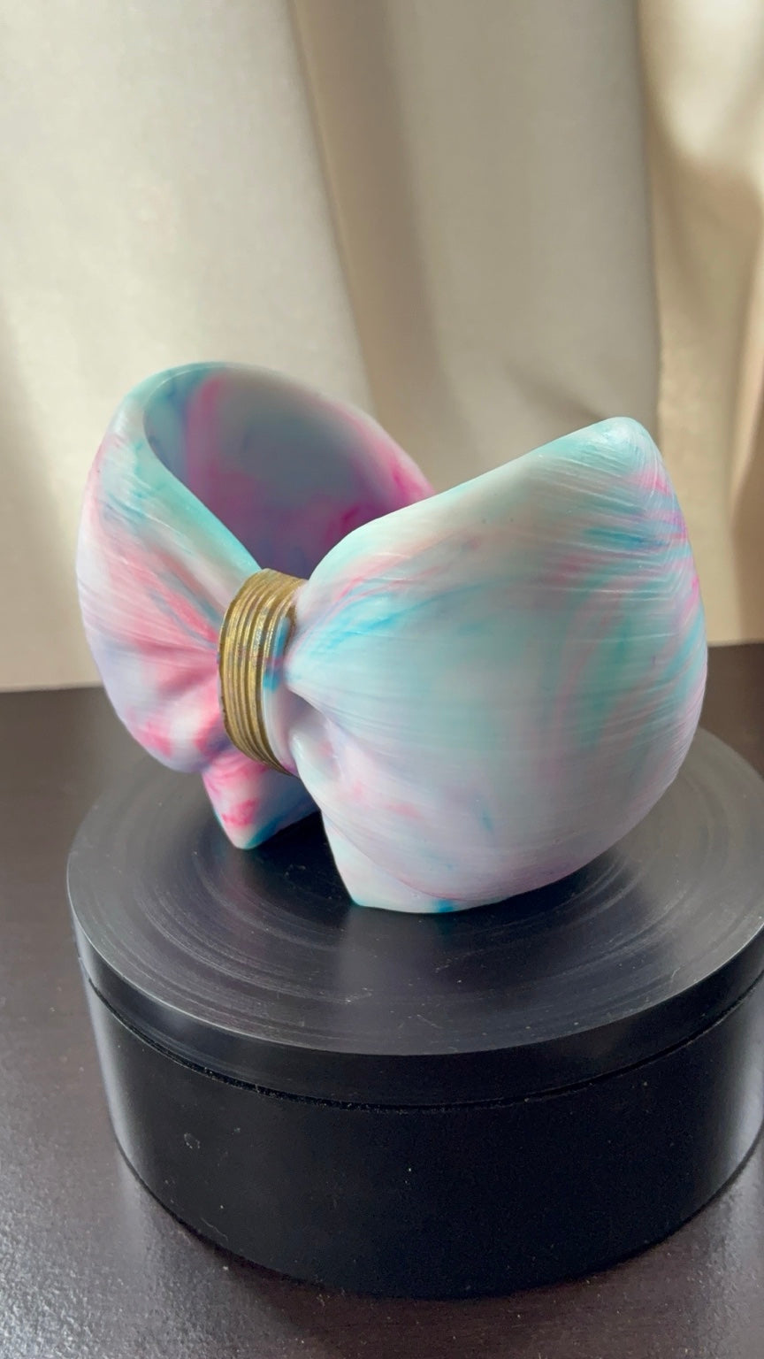 Close angled view of cotton candy tie-dye resin bow holder