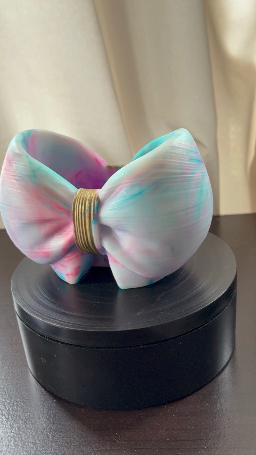 Front view of cotton candy tie-dye resin bow holder with gold center accent