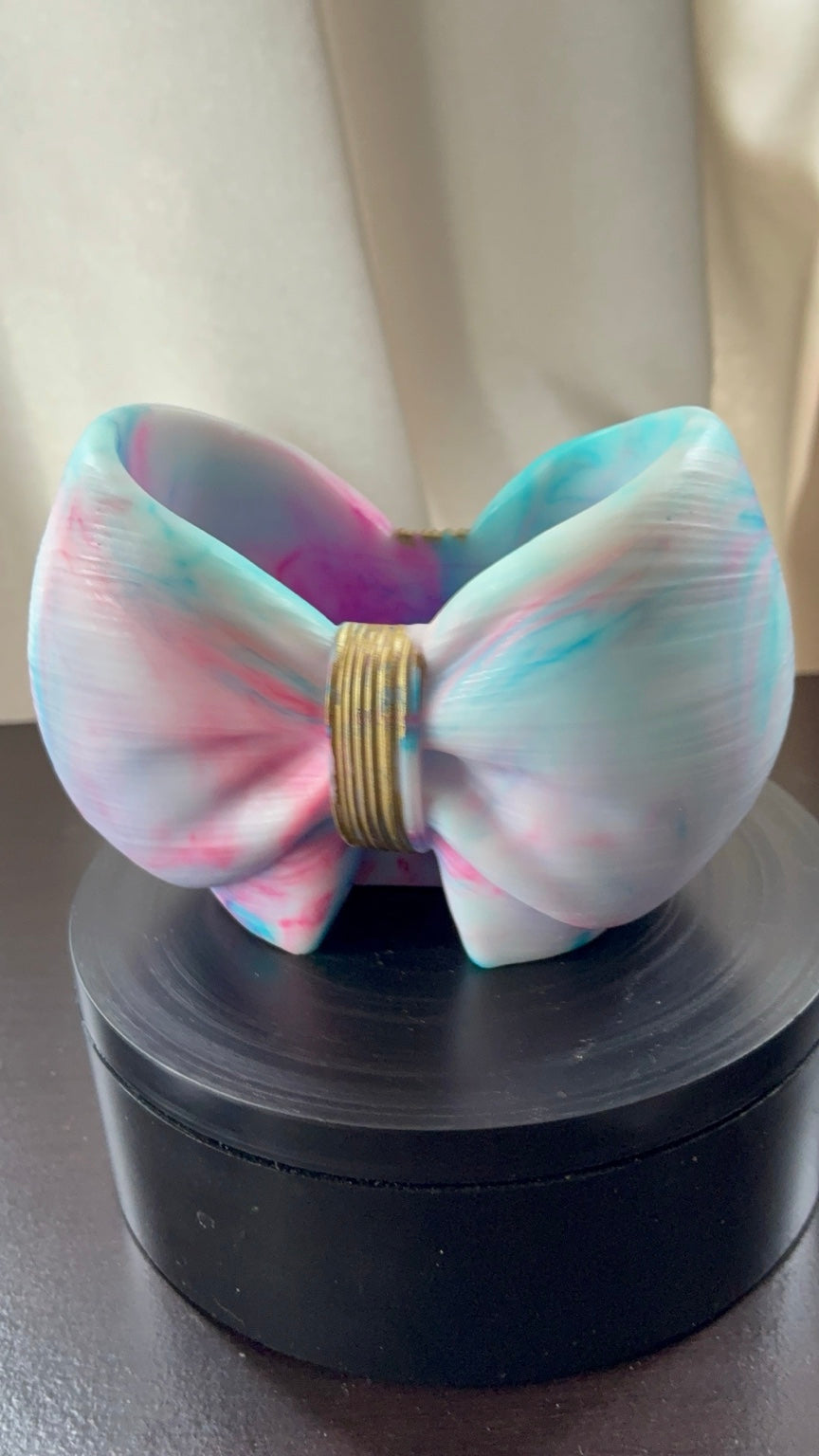 Cotton candy tie-dye resin bow holder showing its open storage area