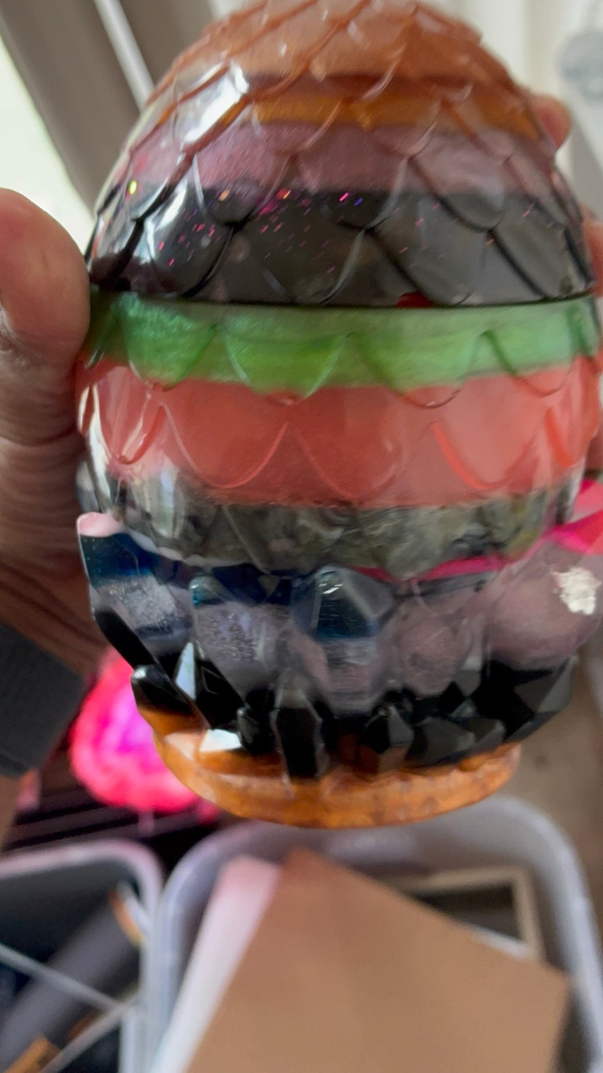 Close-up of layered colors, glitter, and scales on handmade dragon egg resin storage jar