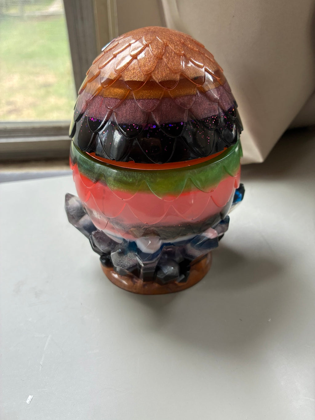Handmade multicolor dragon egg resin storage jar with layered pigments and crystal-style base