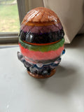 Handmade multicolor dragon egg resin storage jar with layered pigments and crystal-style base