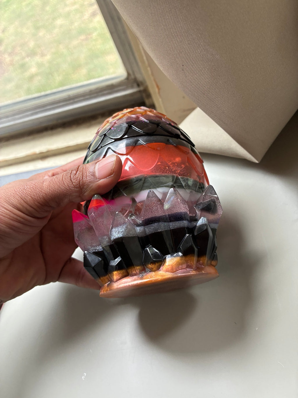 Side view of handmade dragon egg resin storage jar with crystal-style base