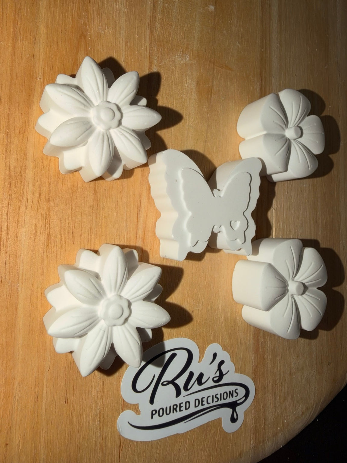 Close-up of detailed flowers and butterfly eco ceramic resin shapes