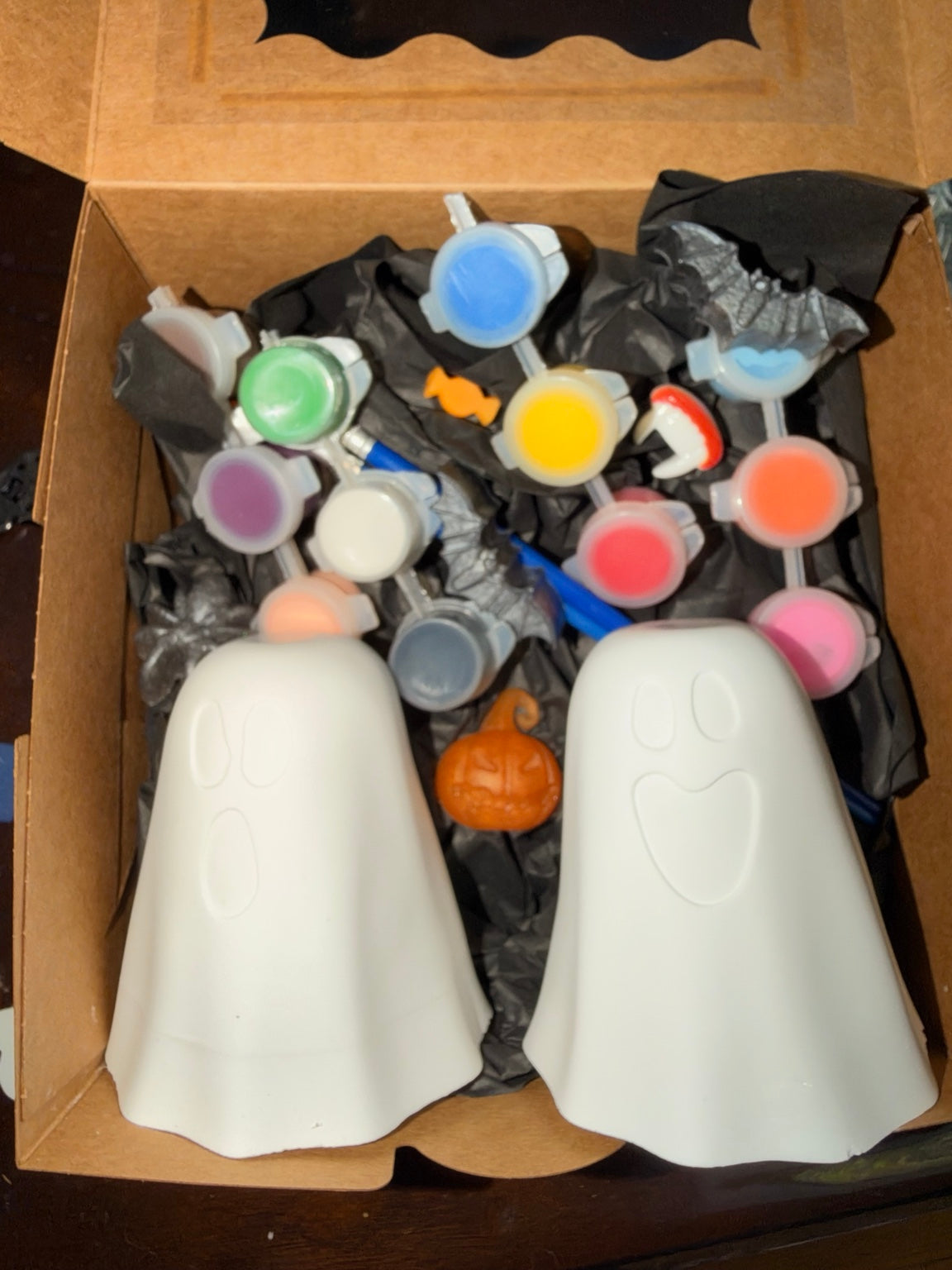 Two eco ceramic resin ghost figures with paint pots and brush