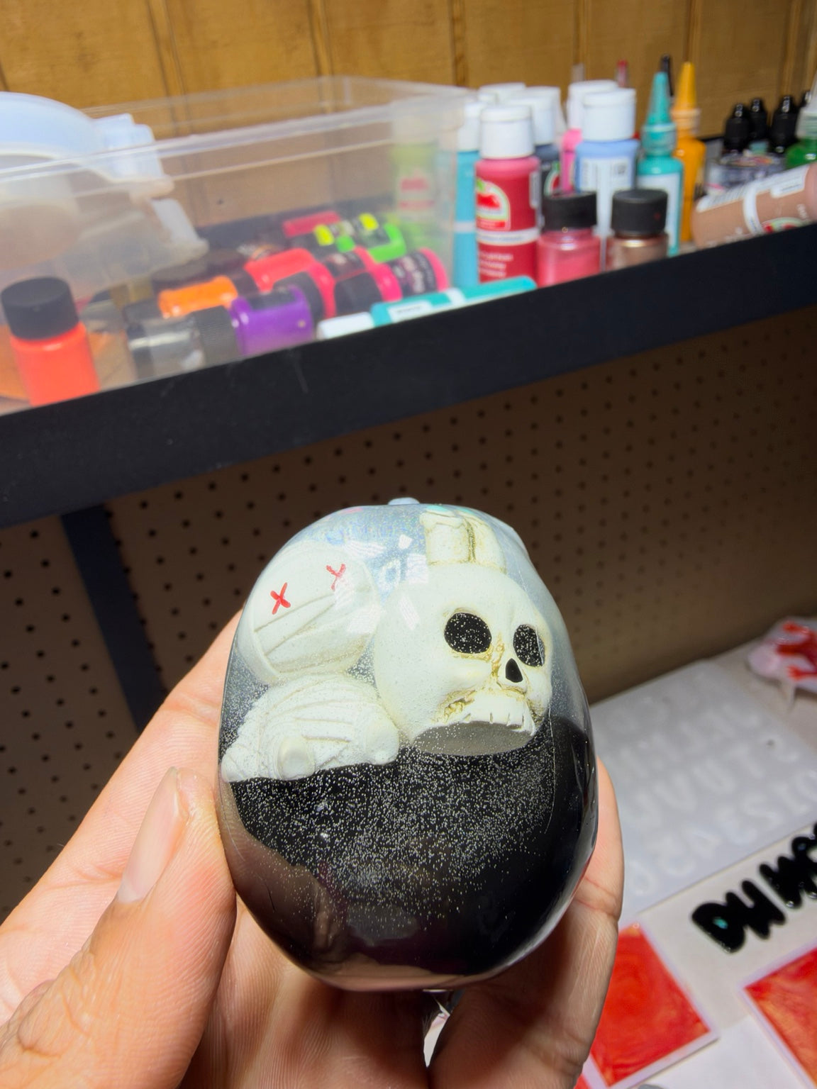 Back view of resin skull showing embedded skeleton and coffin detail