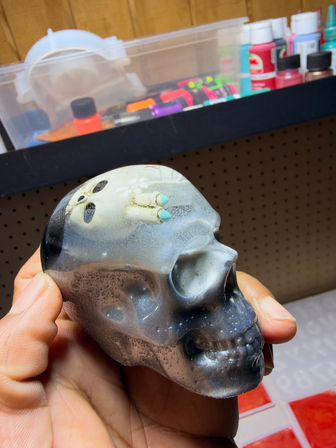 Side view of medium smoky black handmade resin skull