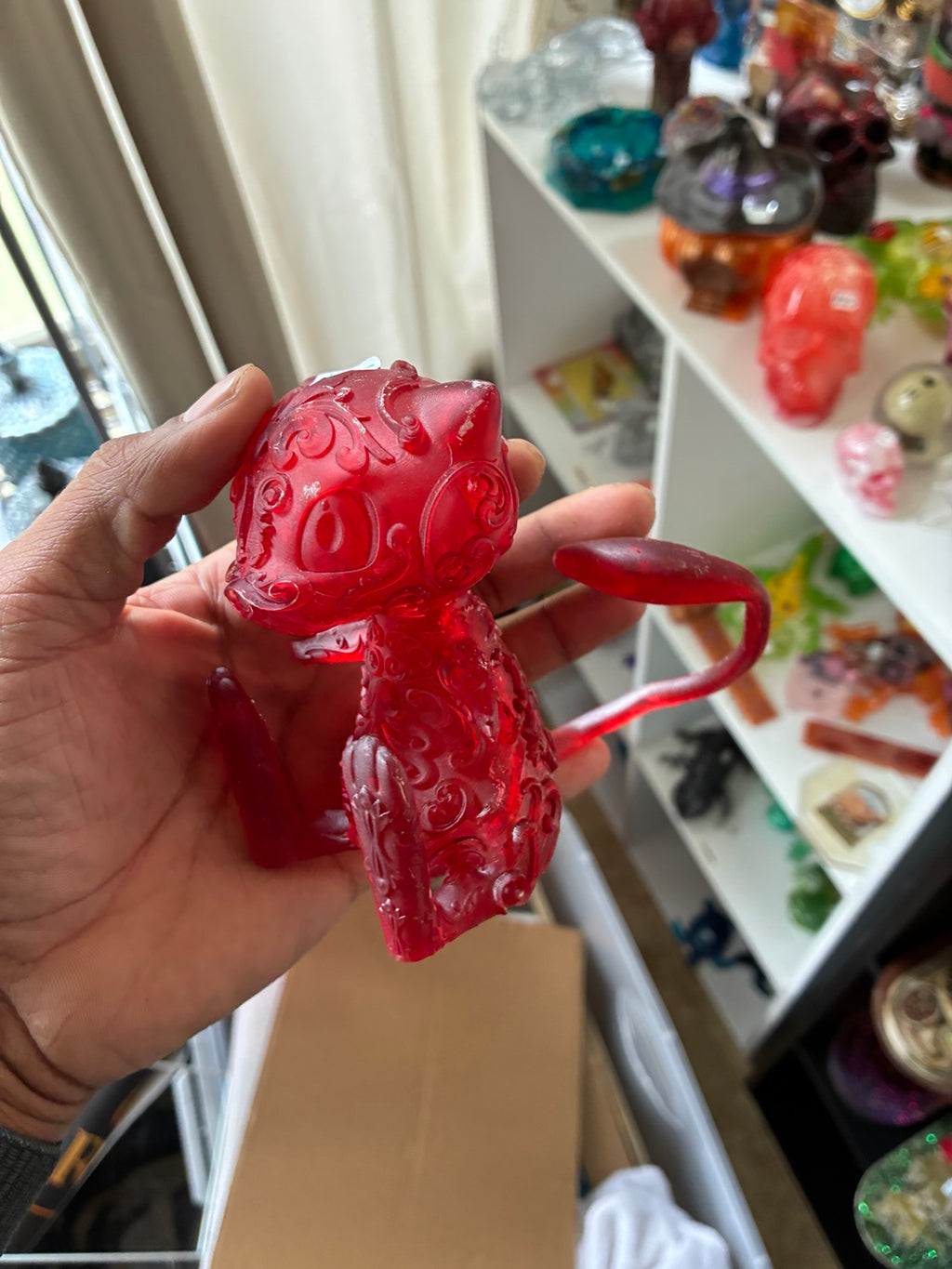 Red translucent Mew-inspired UV resin 3D printed figurine, side view