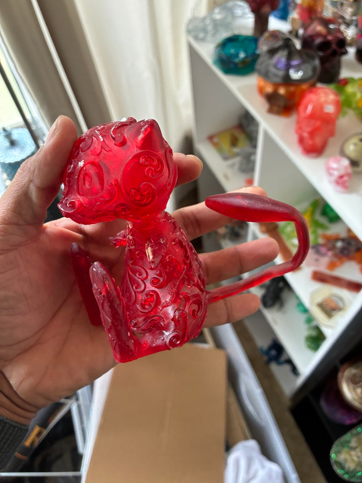 Red translucent Mew-inspired UV resin 3D printed figurine, three-quarter view