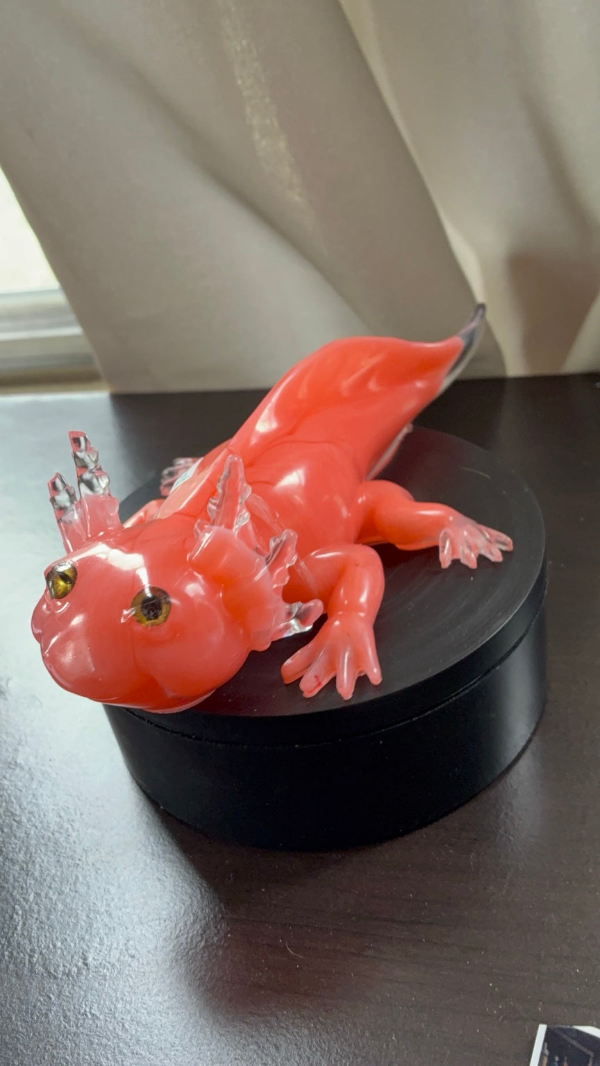 Side view of pink and clear axolotl resin art with realistic detailing