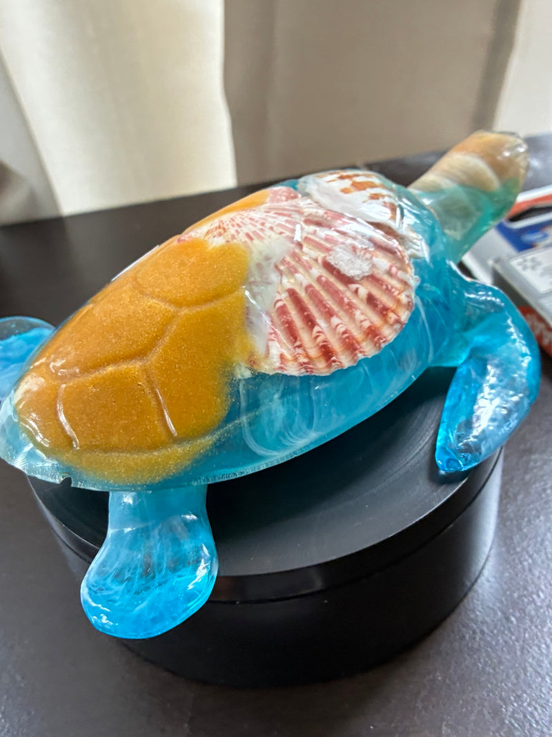 Handmade medium resin sea turtle with preserved seashells, sand, and blue wave design