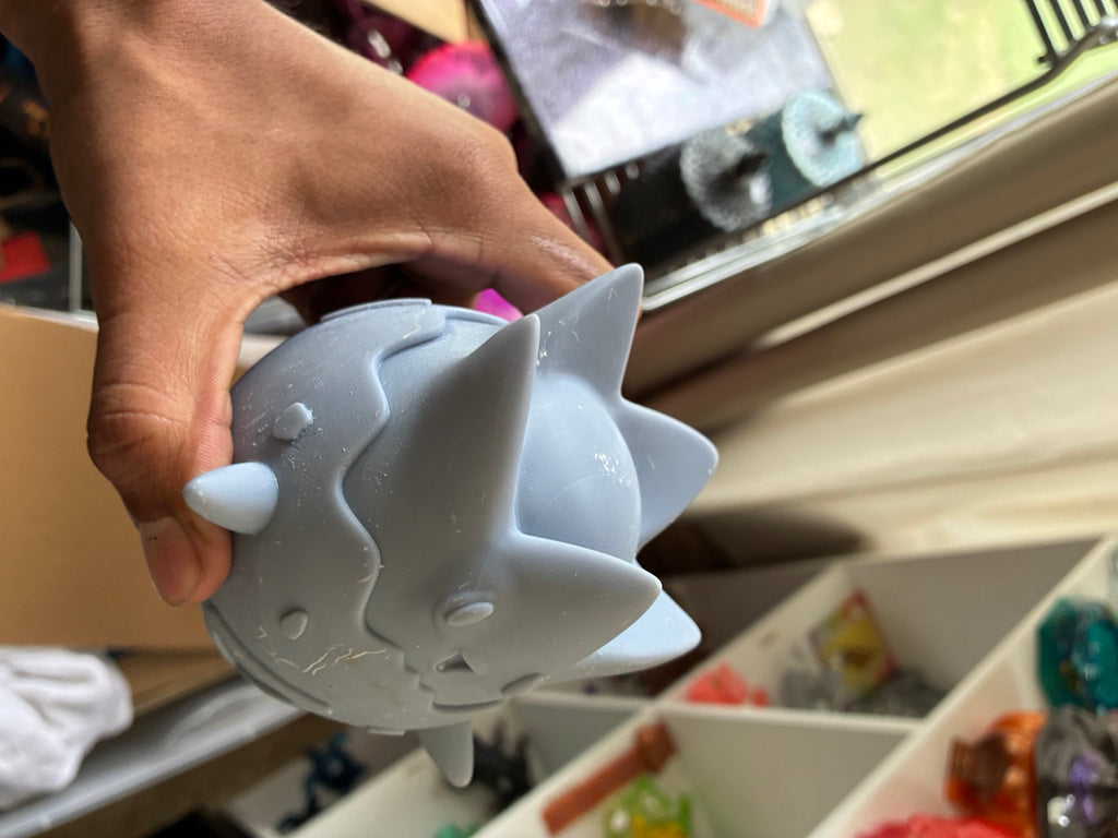 Gray solid Togepi-inspired UV resin 3D printed DIY paint figure, angled front view
