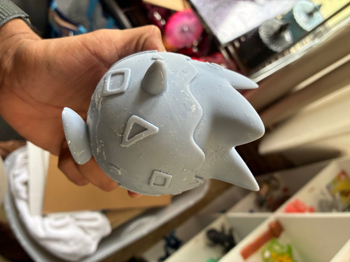 Gray solid Togepi-inspired UV resin 3D printed DIY paint figure, side view showing sanding areas